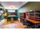Cozy bedroom with dark green walls, wood furnishings, and a unique raised bed frame feature at 16132 Mclester Rd, Oakboro, NC 28129