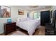 Bedroom featuring hardwood floors, neutral walls, and a bed with light pink linens at 16132 Mclester Rd, Oakboro, NC 28129