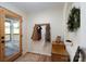 Inviting entryway featuring a wood door with glass, coat rack, wood floors, and neutral walls at 16132 Mclester Rd, Oakboro, NC 28129