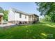 Home exterior featuring a screened-in porch and green lawn at 16132 Mclester Rd, Oakboro, NC 28129