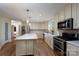 Updated kitchen with island and stainless appliances exudes modern elegance at 16132 Mclester Rd, Oakboro, NC 28129