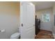 Practical laundry room with a toilet, new washer/dryer, and door leading to the exterior at 16132 Mclester Rd, Oakboro, NC 28129