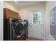 Modern laundry room with updated washer and dryer and access to the backyard at 16132 Mclester Rd, Oakboro, NC 28129