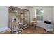 Home office with lots of natural light, designer furniture, shelves, and hardwood floors at 16132 Mclester Rd, Oakboro, NC 28129