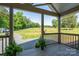 Inviting covered porch offers scenic views of the surrounding green pasture and countryside at 16132 Mclester Rd, Oakboro, NC 28129