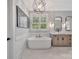Bright bathroom features a soaking tub, sleek vanity with double sinks, and modern lighting at 1622 Hunters Place Rd, York, SC 29745