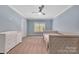 Serene blue bedroom with a ceiling fan, carpet, and built-in daybed with window views at 1622 Hunters Place Rd, York, SC 29745