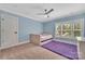 Calm blue bedroom with a ceiling fan, carpet, and a unique built-in daybed, with a purple rug at 1622 Hunters Place Rd, York, SC 29745