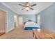 Bedroom with blue walls featuring carpet, a ceiling fan, an ensuite, and a work desk at 1622 Hunters Place Rd, York, SC 29745
