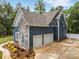 Exterior view of a blue two-story home with a two-car garage and stone accents at 1622 Hunters Place Rd, York, SC 29745
