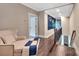 Hallway with hardwood floors, a chaise lounge, and large painting, leading to stairs at 1622 Hunters Place Rd, York, SC 29745