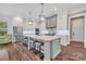 Open concept kitchen showcasing a large island with seating, modern appliances, and stylish pendant lighting at 1622 Hunters Place Rd, York, SC 29745