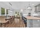 Spacious kitchen and dining area boasts an open floor plan and designer lighting at 1622 Hunters Place Rd, York, SC 29745