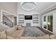 Bright living room featuring a fireplace, a large TV, built-in shelving, and a staircase to upper level at 1622 Hunters Place Rd, York, SC 29745