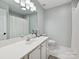 Bathroom featuring a large vanity, mirror, and shower with ample natural light at 17732 Kings Point Dr, Cornelius, NC 28031