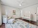 Bright Bedroom with a crib, armchair, rug, and hardwood floors at 17732 Kings Point Dr, Cornelius, NC 28031