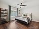 Cozy bedroom with hardwood floors, a ceiling fan, and a comfortable bed at 17732 Kings Point Dr, Cornelius, NC 28031