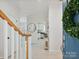 Bright foyer showcasing tile flooring, staircase, and a view of the kitchen with modern appliances at 17732 Kings Point Dr, Cornelius, NC 28031