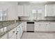 Bright kitchen featuring granite countertops, modern appliances, and white cabinetry with classic black hardware at 17732 Kings Point Dr, Cornelius, NC 28031