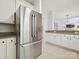 Open kitchen with stainless steel refrigerator, granite countertops, and white cabinetry offers a clean and modern design at 17732 Kings Point Dr, Cornelius, NC 28031