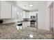Modern kitchen with granite countertops, stainless steel appliances, and ample white cabinets for storage and style at 17732 Kings Point Dr, Cornelius, NC 28031
