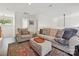 Bright living room featuring a comfortable sofa, stylish rug, and hardwood floors at 17732 Kings Point Dr, Cornelius, NC 28031