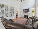 Inviting living room featuring a fireplace, large sectional sofa, and built-in shelving at 17732 Kings Point Dr, Cornelius, NC 28031