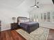 Serene main bedroom features a large bed, vaulted ceiling and plantation shutters, offering comfort and style at 17732 Kings Point Dr, Cornelius, NC 28031