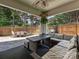 Covered outdoor patio with dining table, ample seating, and a fenced in backyard at 17732 Kings Point Dr, Cornelius, NC 28031