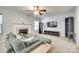 Cozy living room features a fireplace, ceiling fan, and entertainment center at 1791 Rosewell Dr # 65, Rock Hill, SC 29732