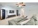 Open living room with a ceiling fan, entertainment center, and access to other spaces at 1791 Rosewell Dr # 65, Rock Hill, SC 29732