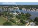 A high aerial shows a scenic waterfront property with lush greenery and neighborhood boat docks at 18118 Pompano Pl, Cornelius, NC 28031