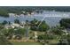 An aerial view shows a neighborhood near a lake, featuring lush landscapes and nearby boat docks at 18118 Pompano Pl, Cornelius, NC 28031