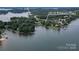 A high aerial showcases a scenic waterfront property with lush greenery and neighborhood boat docks at 18118 Pompano Pl, Cornelius, NC 28031