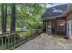 Expansive wooden back deck with a wooden rail and steps leading to a screened in porch at 18118 Pompano Pl, Cornelius, NC 28031