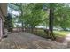 Spacious wooden deck overlooking a serene lake with lush greenery and a peaceful dock area at 18118 Pompano Pl, Cornelius, NC 28031