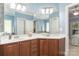 Bathroom featuring a double vanity, framed mirror, and updated fixtures at 18118 Pompano Pl, Cornelius, NC 28031
