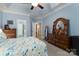 Comfortable bedroom featuring blue walls, a ceiling fan, carpeted floors, and ensuite bathroom at 18118 Pompano Pl, Cornelius, NC 28031