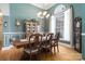 Elegant dining room with hardwood floors, china cabinet, and a large window for natural lighting at 18118 Pompano Pl, Cornelius, NC 28031