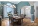 Bright dining room featuring hardwood floors, a large window, and elegant chandelier lighting at 18118 Pompano Pl, Cornelius, NC 28031