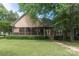 Charming exterior of a home with a screened-in porch, manicured lawn, and lush landscaping at 18118 Pompano Pl, Cornelius, NC 28031