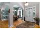 Elegant foyer featuring hardwood floors, an arched doorway, and a view of the dining room's natural light at 18118 Pompano Pl, Cornelius, NC 28031