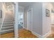 Inviting hallway offers access to stairs, laundry room, and other areas of the home at 18118 Pompano Pl, Cornelius, NC 28031