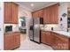 Updated kitchen featuring stainless steel appliances and cherry cabinets at 18118 Pompano Pl, Cornelius, NC 28031