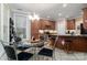 Cozy kitchen nook with a glass table, chandelier, and views into the kitchen at 18118 Pompano Pl, Cornelius, NC 28031