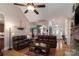Cozy living room with hardwood floors, a ceiling fan, and arched doorways leading to other living spaces at 18118 Pompano Pl, Cornelius, NC 28031