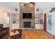 Comfortable living room featuring a stone fireplace, built-in shelving and hardwood flooring at 18118 Pompano Pl, Cornelius, NC 28031