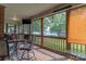Relaxing screened-in porch with seating, TV and scenic views of the serene lake at 18118 Pompano Pl, Cornelius, NC 28031