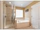 Bright bathroom showcasing a separate shower, garden tub, and large window at 1905 Yellow Daisy Dr, Matthews, NC 28104