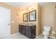 Bathroom features a double vanity with granite countertop, framed mirrors, and tile flooring at 1905 Yellow Daisy Dr, Matthews, NC 28104